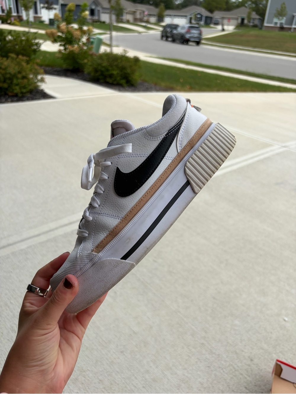 Nike White Low-Top Sneakers with Black Swoosh and Tan Accent